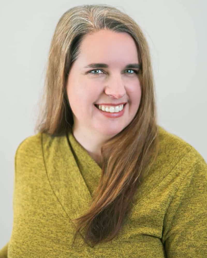 leanne-mitton Leanne Mitton smiling and wearing a green sweater
